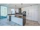 This modern kitchen boasts an island with gray countertops, sleek white cabinetry, and stainless steel appliances at 777 3Rd N Ave # 908, St Petersburg, FL 33701