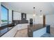 This modern kitchen boasts a large island with gray countertops, sleek white cabinetry, and stainless steel appliances at 777 3Rd N Ave # 908, St Petersburg, FL 33701