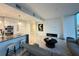 Open-concept living room with a modern kitchen, marble floors, and a sleek electric fireplace at 777 3Rd N Ave # 908, St Petersburg, FL 33701