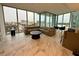Bright, open-concept living area with floor-to-ceiling windows offering stunning city views at 777 3Rd N Ave # 908, St Petersburg, FL 33701