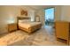 This modern bedroom has marble floors, a wood bed frame and views of the city from the floor to ceiling window at 777 3Rd N Ave # 908, St Petersburg, FL 33701