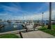 A tranquil marina scene features a charming bench overlooking sailboats docked under a blue sky at 777 3Rd N Ave # 908, St Petersburg, FL 33701