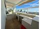 This outdoor kitchen features bar seating, a sink, fridge, stainless steel cabinets and lovely city views at 777 3Rd N Ave # 908, St Petersburg, FL 33701