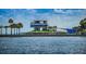 Waterfront view featuring a contemporary structure with multiple tiers and palm trees at 777 3Rd N Ave # 908, St Petersburg, FL 33701