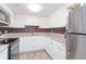 Modern kitchen with white cabinets, granite countertops, and stainless steel appliances at 2462 Brazilia Dr # 38, Clearwater, FL 33763