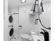 Clean bathroom with white vanity, toilet and stackable washer/dryer at 489 Wood St, Dunedin, FL 34698