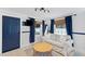 Living room with light walls, navy blue accents, and wicker coffee table at 489 Wood St, Dunedin, FL 34698