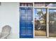 Blue front door of a condo with glass panel at 18399 Gulf Blvd # 372, Indian Shores, FL 33785