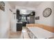 Cozy kitchen with dark cabinetry and breakfast nook at 18399 Gulf Blvd # 372, Indian Shores, FL 33785