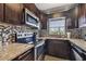 Modern kitchen with dark wood cabinets and granite countertops at 18399 Gulf Blvd # 372, Indian Shores, FL 33785