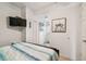 Bright bedroom with a queen bed and access to the hallway at 18399 Gulf Blvd # 372, Indian Shores, FL 33785