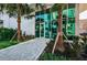 Modern building entrance with palm trees and geometric tile walkway at 777 3Rd N Ave # 908, St Petersburg, FL 33701
