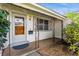 Inviting front porch with decorative railing and a wood front door at 6087 16Th Ne Ln, St Petersburg, FL 33703