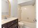 Bathroom includes a bathtub, toilet, and dark wood vanity with a beige countertop at 3856 Goldfinch Ct, Palm Harbor, FL 34685