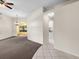 Spacious living room with neutral carpeting and a ceiling fan at 3856 Goldfinch Ct, Palm Harbor, FL 34685