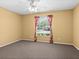 Another bedroom with carpet flooring, a window and ceiling fan at 3856 Goldfinch Ct, Palm Harbor, FL 34685