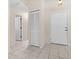 Clean entryway with tile flooring, built-in storage, and access to other rooms at 3856 Goldfinch Ct, Palm Harbor, FL 34685