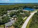 Aerial view of a residential community near a lake at 3856 Goldfinch Ct, Palm Harbor, FL 34685