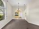 Bright dining room with a chandelier and carpet flooring at 3856 Goldfinch Ct, Palm Harbor, FL 34685