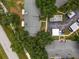 Aerial view of a community featuring multiple buildings, lush trees, and ample parking at 3856 Goldfinch Ct, Palm Harbor, FL 34685