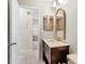 A second bathroom with a vanity, toilet and access to another room at 3856 Goldfinch Ct, Palm Harbor, FL 34685