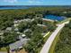 Aerial view of community near a lake and main road at 3856 Goldfinch Ct, Palm Harbor, FL 34685