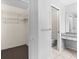 Bathroom features a walk-in closet, toilet, and shower with granite vanity at 3856 Goldfinch Ct, Palm Harbor, FL 34685