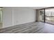 Open living area with hardwood floors and balcony view at 400 Island Way # 308, Clearwater, FL 33767
