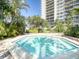 Community hot tub surrounded by lush landscaping at 400 Island Way # 308, Clearwater, FL 33767