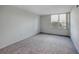 Spacious bedroom with gray carpeting and large window at 400 Island Way # 308, Clearwater, FL 33767