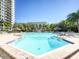 Inviting community pool with ample lounge chairs at 400 Island Way # 308, Clearwater, FL 33767