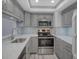 Updated kitchen featuring gray cabinets and stainless steel appliances at 400 Island Way # 308, Clearwater, FL 33767