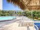 White lounge chairs around the refreshing blue pool at 400 Island Way # 308, Clearwater, FL 33767