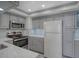 Modern kitchen featuring stainless steel appliances and gray cabinetry at 400 Island Way # 308, Clearwater, FL 33767