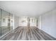 Large living room with mirrored wall and hardwood floors at 400 Island Way # 308, Clearwater, FL 33767