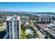 Aerial view of waterfront community with pool and multiple high-rise buildings at 400 Island Way # 308, Clearwater, FL 33767