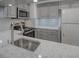 Modern kitchen with gray cabinets and stainless steel appliances at 400 Island Way # 308, Clearwater, FL 33767