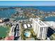 Aerial view showing a high-rise building, pool, and surrounding neighborhood at 400 Island Way # 308, Clearwater, FL 33767