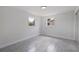 Well-lit bedroom with tile flooring and dual windows at 6840 Runnel Dr, New Port Richey, FL 34653