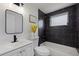 Bathroom with dark tile, white vanity, and bathtub at 6840 Runnel Dr, New Port Richey, FL 34653