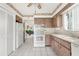 View of kitchen with white appliances and wood cabinets at 4445 Pelorus Dr, New Port Richey, FL 34652