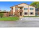 Two-story building with brown accents and outdoor stairs at 4445 Pelorus Dr, New Port Richey, FL 34652