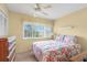Bedroom with ceiling fan and floral bedding at 4445 Pelorus Dr, New Port Richey, FL 34652