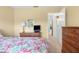 Cozy bedroom with floral bedding and wood dresser at 4445 Pelorus Dr, New Port Richey, FL 34652