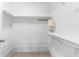 Spacious walk-in closet with wire shelving and a lamp at 4445 Pelorus Dr, New Port Richey, FL 34652