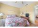 Bright bedroom with ceiling fan and floral bedding at 4445 Pelorus Dr, New Port Richey, FL 34652