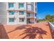 Large balcony with tile flooring and access to building amenities at 1 Seaside Ln # 104, Belleair, FL 33756