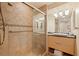 Updated bathroom with walk-in shower, granite vanity, and tile flooring at 1 Seaside Ln # 104, Belleair, FL 33756