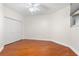 Spacious bedroom with hardwood floors and mirrored closet doors at 1 Seaside Ln # 104, Belleair, FL 33756