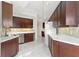 Modern kitchen with dark wood cabinets and white countertops at 1 Seaside Ln # 104, Belleair, FL 33756